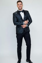 Amsterdam Peak Tuxedo Jacket modeled by man in black patterned fabric with peak lapels and bow tie.
