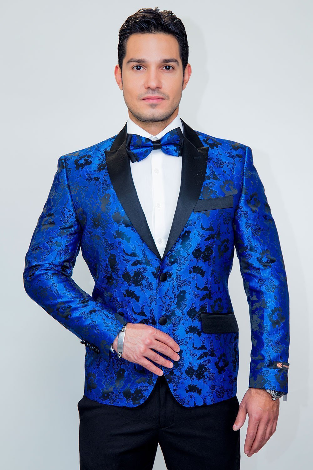 Amsterdam Tuxedo Jacket Peak in royal blue floral satin with black lapels and matching bow tie.