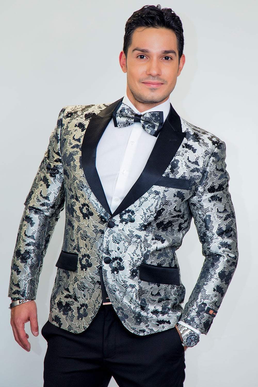 Man wearing Amsterdam Tuxedo Jacket Peak: metallic floral black-silver blazer with peak lapels and bow tie.